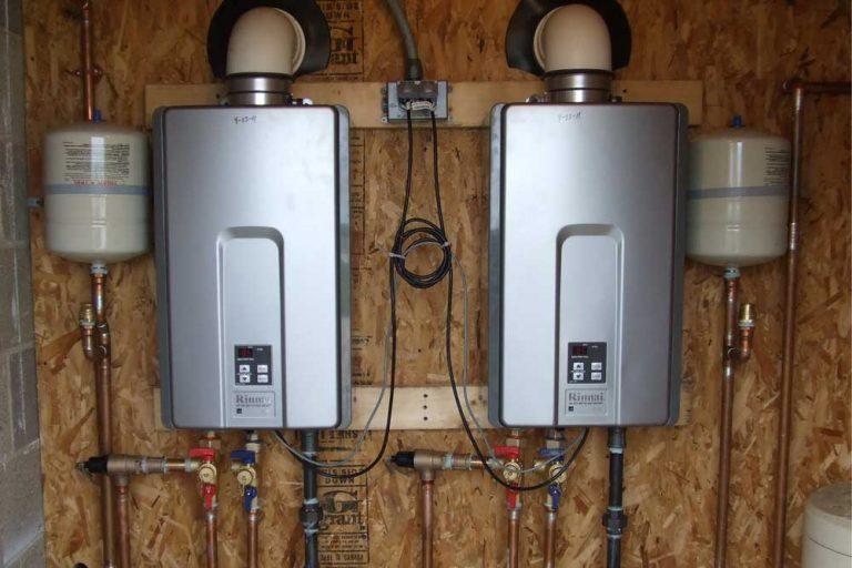 Two-tankless-water-heaters-installed-and-mounted-on-basement-wall