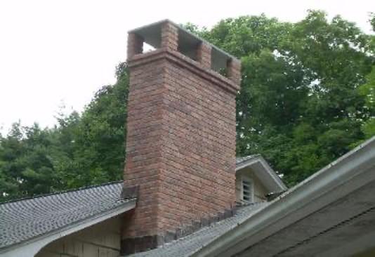 Brick chimney with cap.