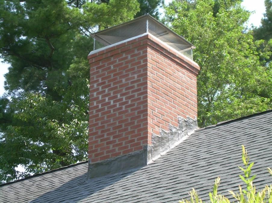 Brick chimney with mesh cap.