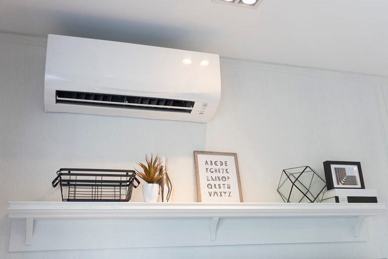 Air conditioner split type embed on wall of living room.